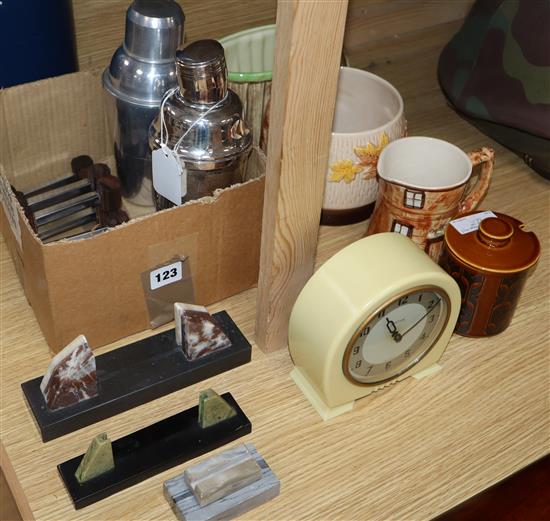 A plated Art Deco cocktail shaker, photo frames and knife rests etc